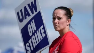 woman stands a picket line