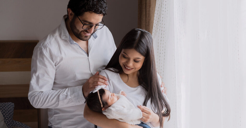 Parents with baby by window